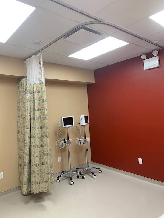 Hospital cubicle curtains stacked on wall