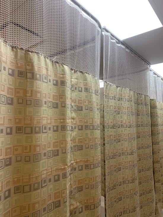 Hospital cubicle curtain on tracks in closed position